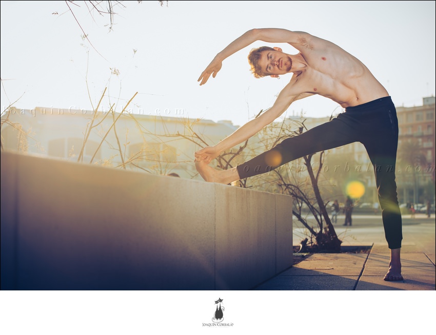 Young Man Performing Joint Movement Exercise Inspired By Yoga, Outdoors.